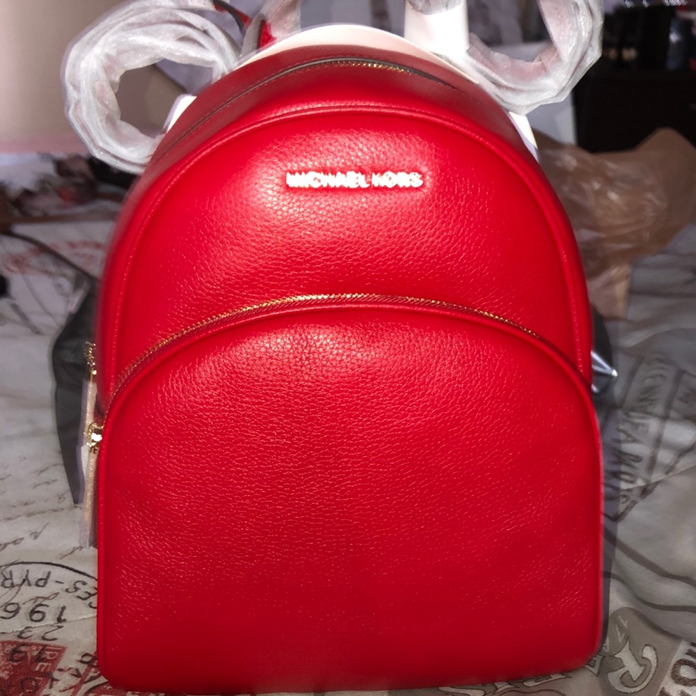 A all red Michael Kors backpack